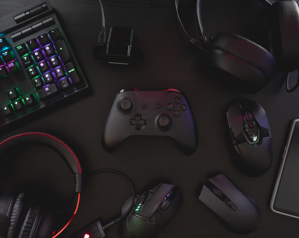 玩家工作空间概念，俯视图游戏设备，鼠标，键盘，操纵杆，耳机，移动操纵杆，在耳机和鼠标垫的黑色桌面背景。图片下载