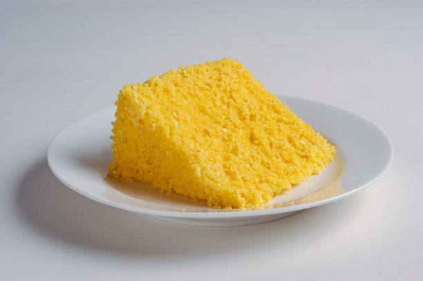 美食。一片来自巴西东北部的传统玉米蒸粗麦粉，放在一个白色的盘子里图片下载