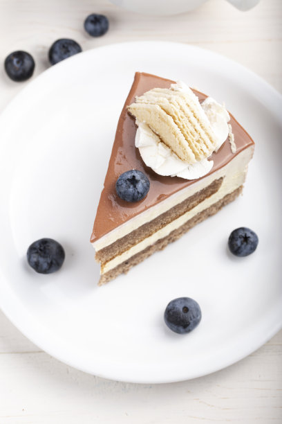 桌子上的盘子里有奶油蛋糕。图片下载