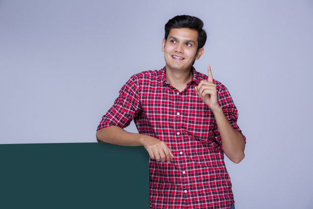 快乐的年轻人拿着一张白色广告牌库存照片图片下载