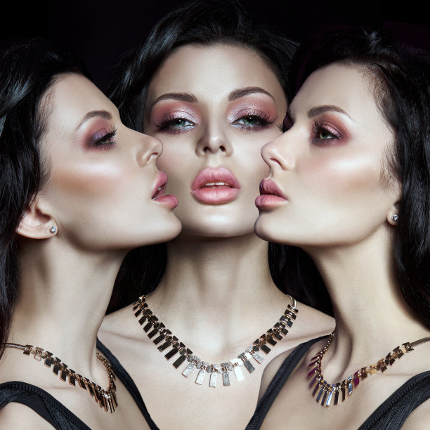 一个黑发女人的肖像，她的发型很别致，脖子上戴着项链和珠宝。自然的化妆品和美丽明亮的化妆在女孩的脸上图片下载