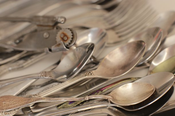 白色餐桌背景上空着餐具。家庭用品:勺子，叉子，刀图片下载