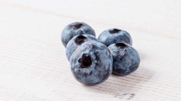木质背景上的新鲜蓝莓。图片下载