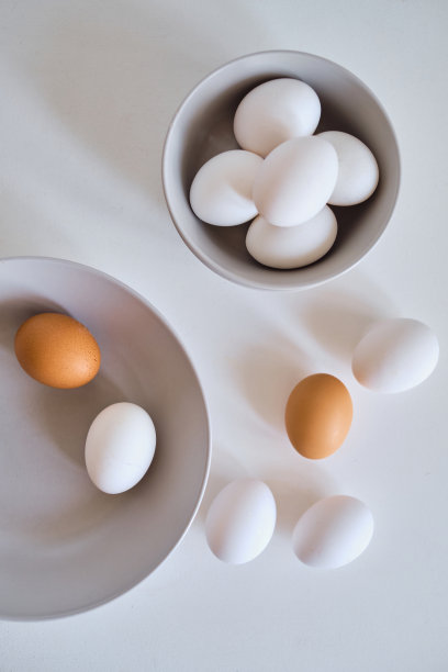在极简的盘子里放鸡蛋。艺术照片，白色桌子上的生鸡蛋。天然有机农产品。为复活节假期做准备。厨房艺术，菜肴菜肴。生料烹调食用图片下载
