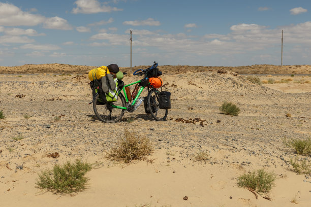 哈萨克斯坦的大草原上停着一辆旅行者用的自行车图片下载