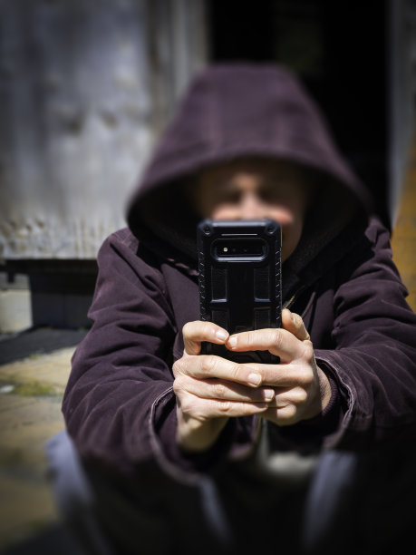 坐在阳光下用手机查看信息的人图片下载