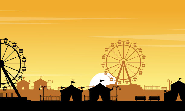 橘色天空下游乐园的剪影图片下载