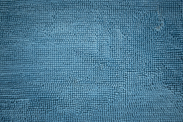 蓝色浴室地毯织物纹理细节。图片下载