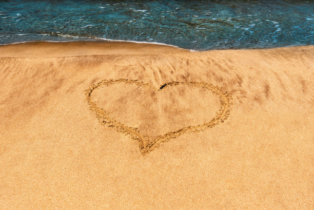 心被画在沙滩上，在沙滩上，在海岸上。图片下载