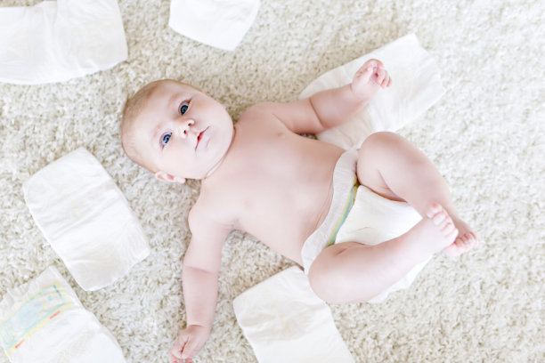 可爱可爱的3个月的新生儿和尿布。快乐的小女孩或小男孩看着镜头。为儿童提供干燥健康的身体和皮肤概念。宝宝幼儿园图片下载