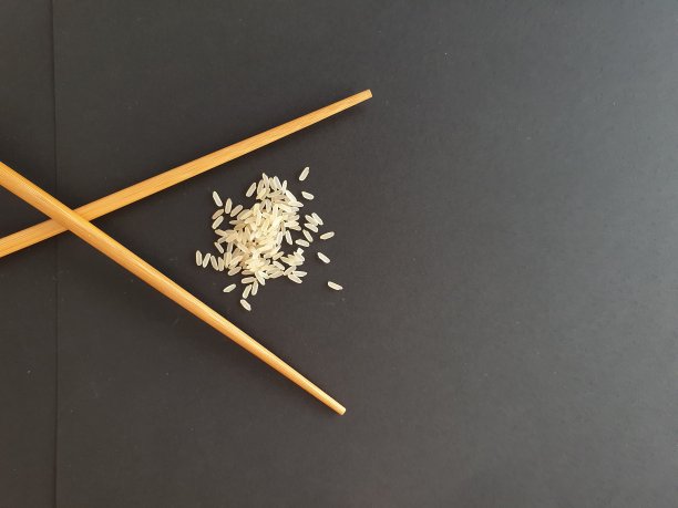 寿司。俯视图的筷子和米饭。的背景图片。日本概念，日本料理，中国料理，亚洲料理。木制的寿司。有用的模板配方准备，餐厅菜单。图片下载