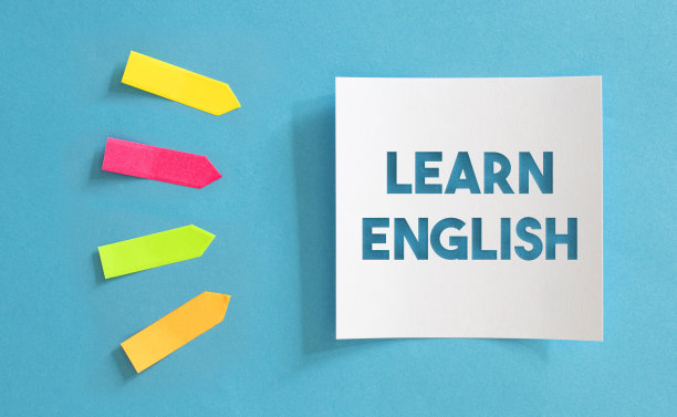 彩色黏贴纸和白纸与学习英语消息在蓝色的纸。图片下载
