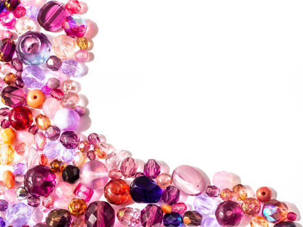 珠子的背景。彩色的珠子在粉红色，紫色，红色，紫罗兰和里拉颜色上的白色图片下载