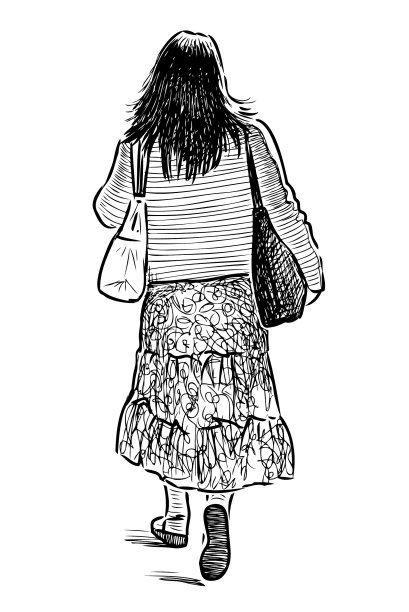 一个年轻女人拿着包走在街上图片下载