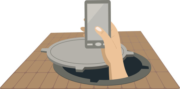 手拿着电话从下水道的人孔中升起图片下载