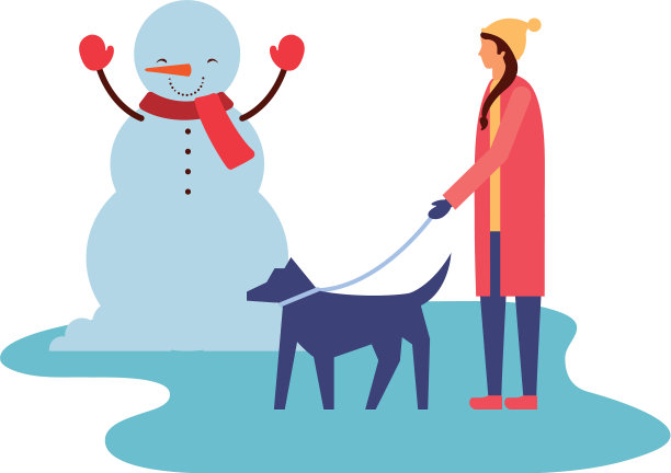 一个女人带着她的狗在冬天堆雪人图片下载