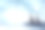 两只可爱的企鹅在雪地里的一块岩石上。素材图片