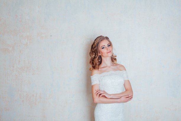 美丽的新娘摆着婚礼的发型和礼服图片下载