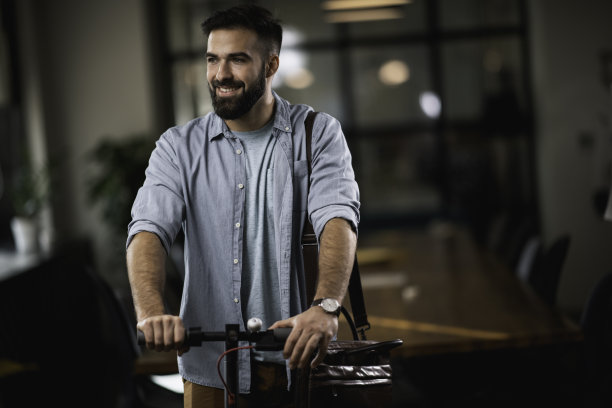 在办公室里驾驶电动车的商人。图片下载