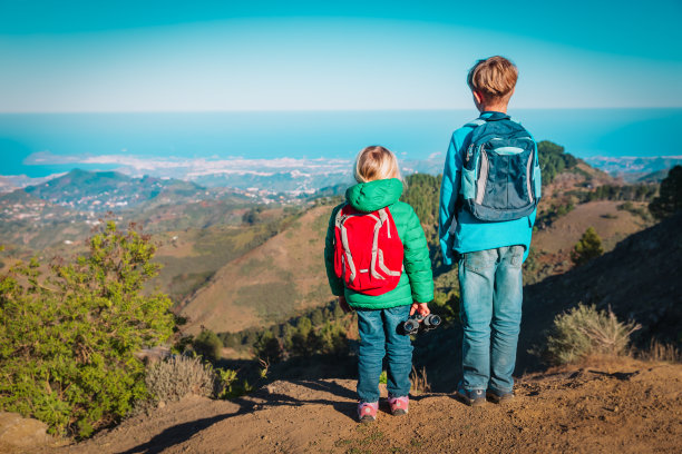 男孩和女孩在山上旅行，家庭在大自然中远足图片下载