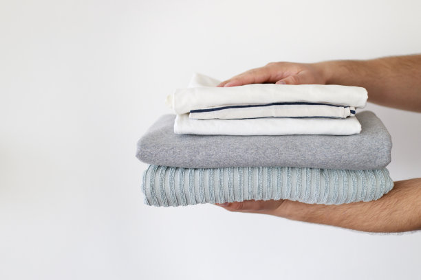 男人手里拿着一堆洗干净的衣服图片下载