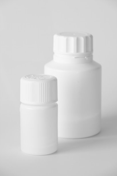 灰色表面上的白色塑料药瓶图片下载