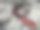 一条红色闪亮的领带，从一件白色衬衫上的一个有图案的窗户里伸出来。图片下载