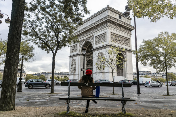 年轻的亚洲旅行者坐在凯旋门的视野中图片下载