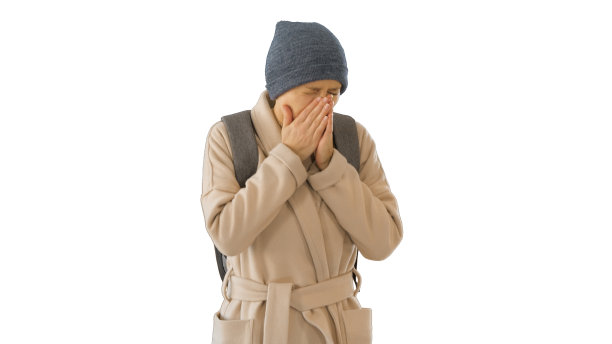 穿着大衣的女人在白色的背景上行走和咳嗽图片下载