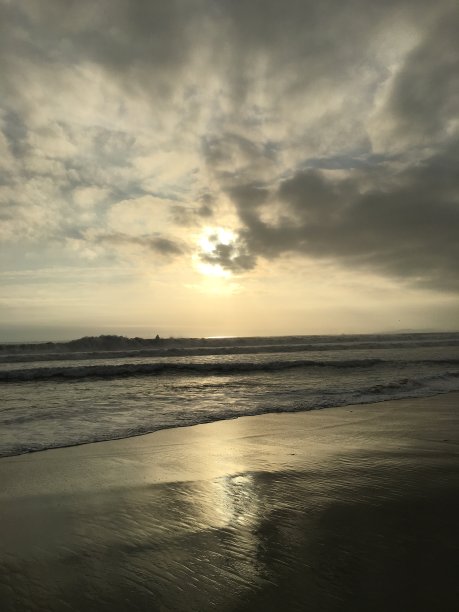 暴风雨的夕阳倒映在沙滩上图片下载