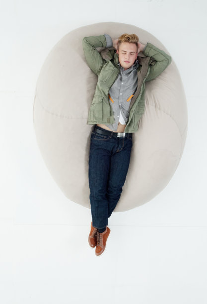 白种人男孩放松在白色背景下穿着夹克图片下载