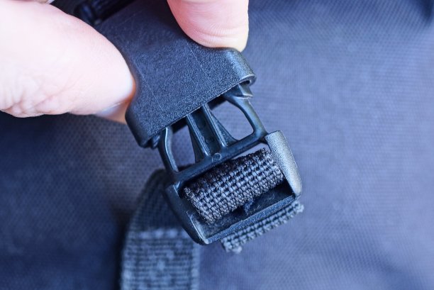 手指握着一个闭合的黑色塑料扣图片下载