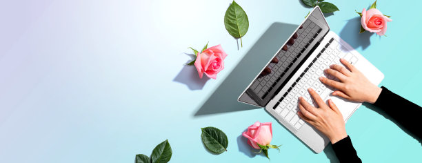 一个带着粉色玫瑰的女人用着笔记本电脑图片下载