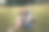 长发女子和背着背包坐在森林草地上的男子。享受大自然的乐趣，拥抱和亲吻图片下载
