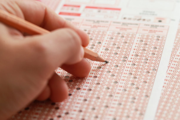 在学校，学生们用铅笔在答题纸上做测验图片下载