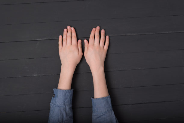 孩子们的手放在黑色背景上。顶部视图的手在衬衫图片下载