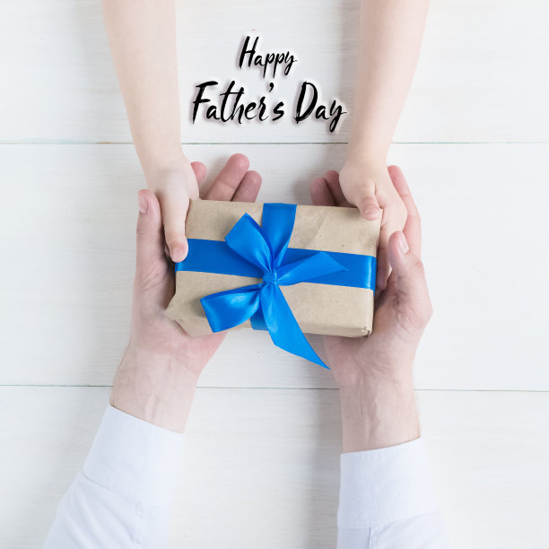 祝您父亲节快乐。贺卡。礼物在女儿和父亲的手中在一个白色的背景。我爱你，爸爸。爱和健康的家庭。图片下载