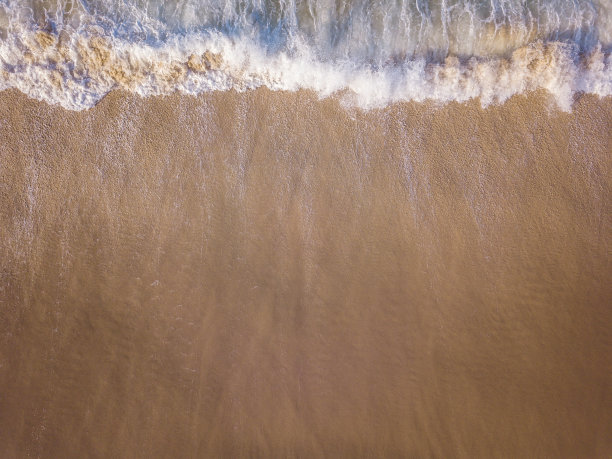海浪拍打海滩的无人机图片。图片下载