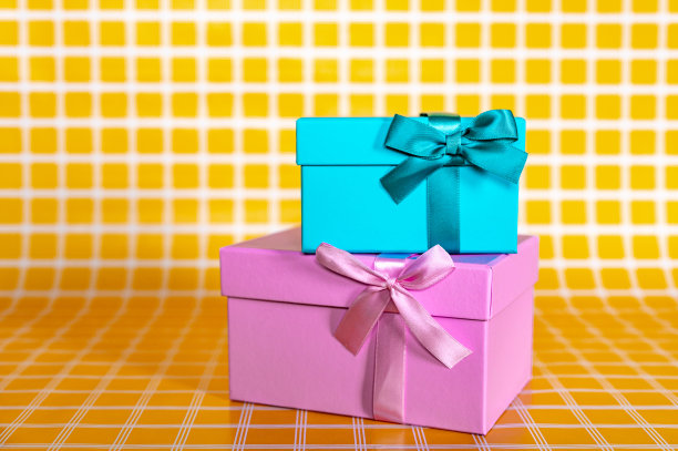 一堆粉色和蓝色礼品盒上的黄色方格背景照片图片下载