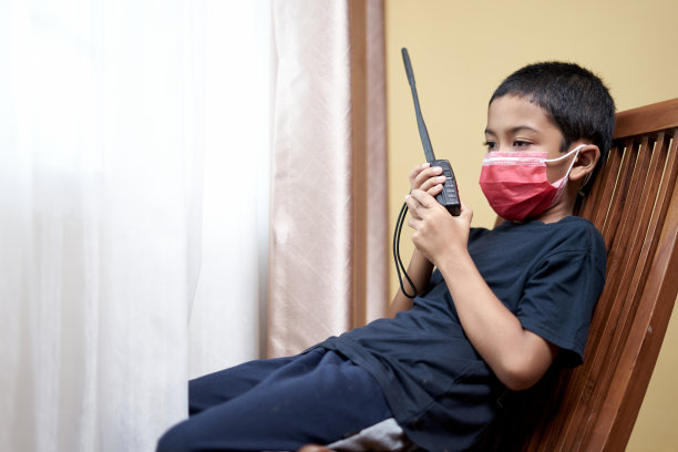 悲伤的男孩用对讲机和透过家庭隔离窗口进行交流图片下载