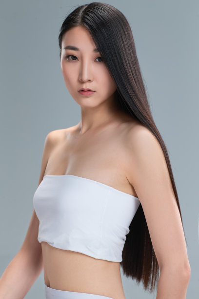 青年女人展示亮丽丝缎般的头发图片下载