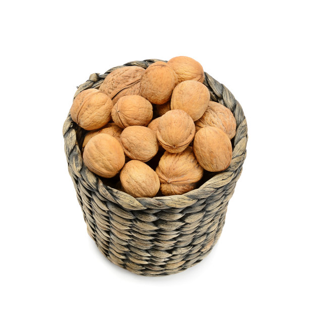 白色背景上的木篮子里的核桃。图片下载