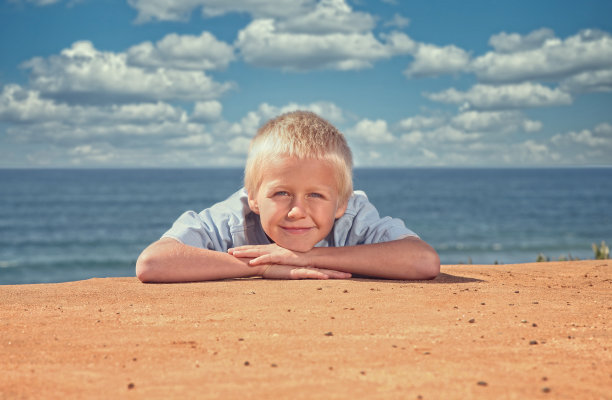 海滩上六岁的金发男孩图片下载
