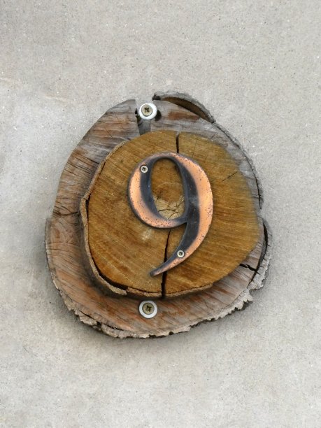 9号房子在墙上的木质底座上图片下载