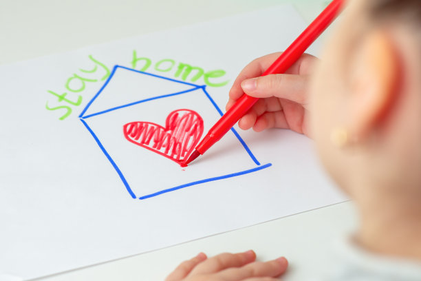 孩子正在用心画房子。图片下载