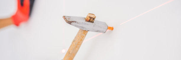 人拧一个螺丝进入墙上横幅，长格式图片下载