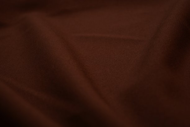 深棕色织物纹理特写。低调照片。丛线程。服装行业。抽象的背景。图片下载