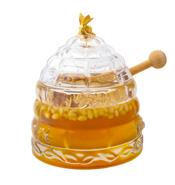 美味的蜂蜜和雪松坚果在一个玻璃罐在白色的背景图片下载