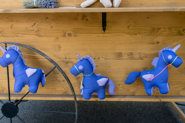 在美食节期间，紫色的独角兽玩具挂在一辆货车的绳子上图片下载