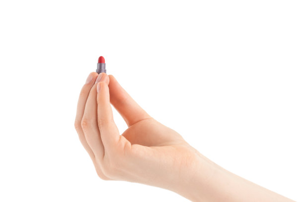一个女人手里拿着迷你口红测试器。红色的口红。美容化妆品，化妆概念。孤立在白色背景上。图片下载